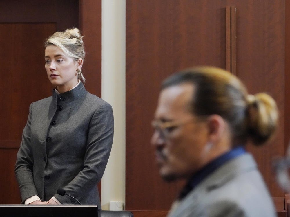 Actors Amber Heard and Johnny Depp watch as the jury leave the courtroom for a lunch break at the Fairfax County Circuit Court in Fairfax, Va. on Monday.