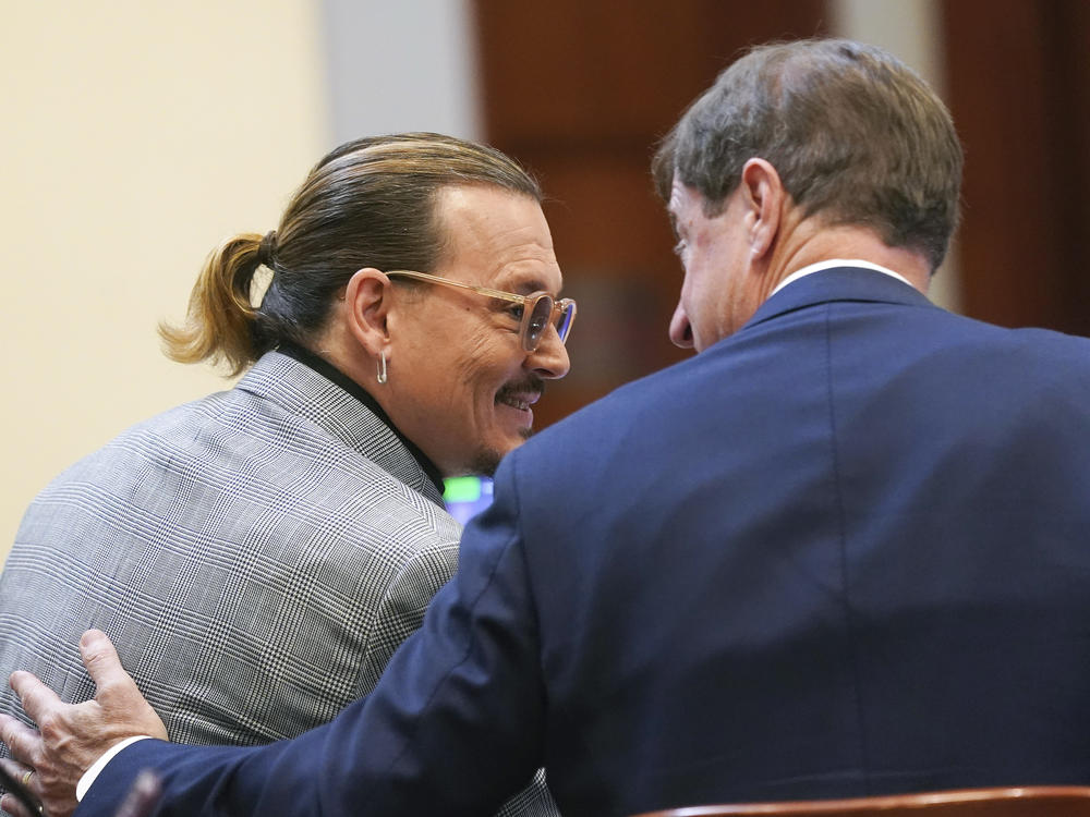 Actor Johnny Depp speaks with his legal team in the courtroom at Fairfax County Circuit Court in Fairfax, Va. on Thursday.