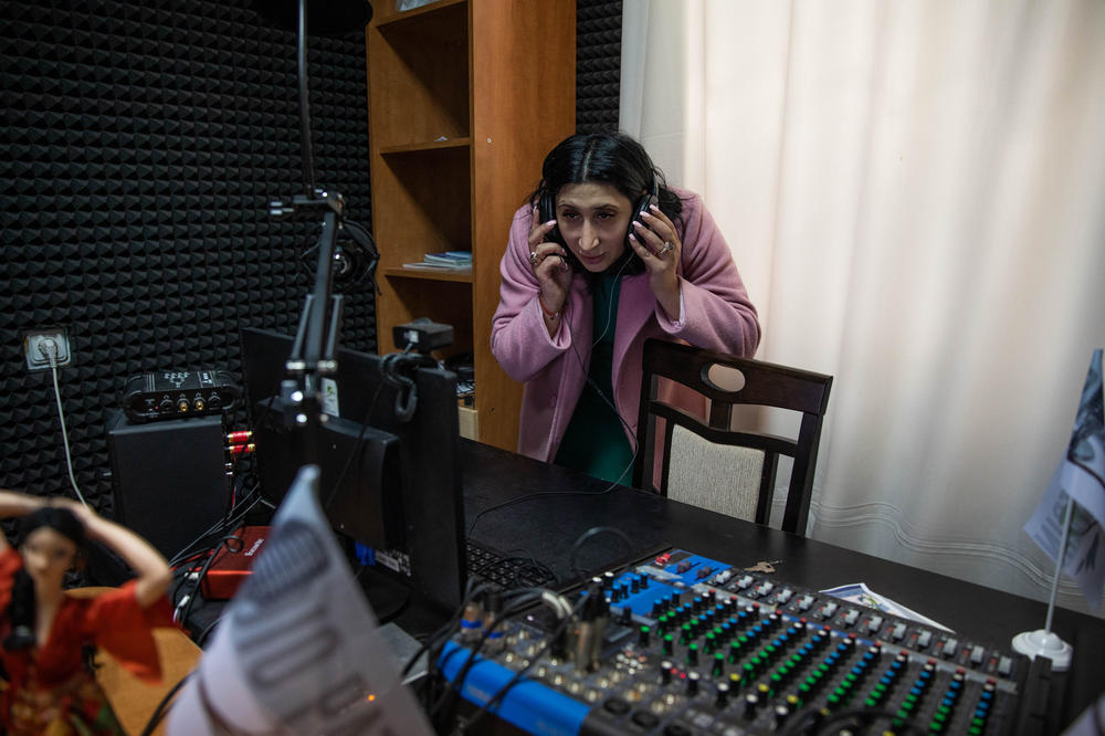 Victorina Luca, a human rights lawyer and founder of the Roma Awareness Foundation, stands in the Chisinau studio of her radio program, which has started broadcasting information for Roma coming from Ukraine.