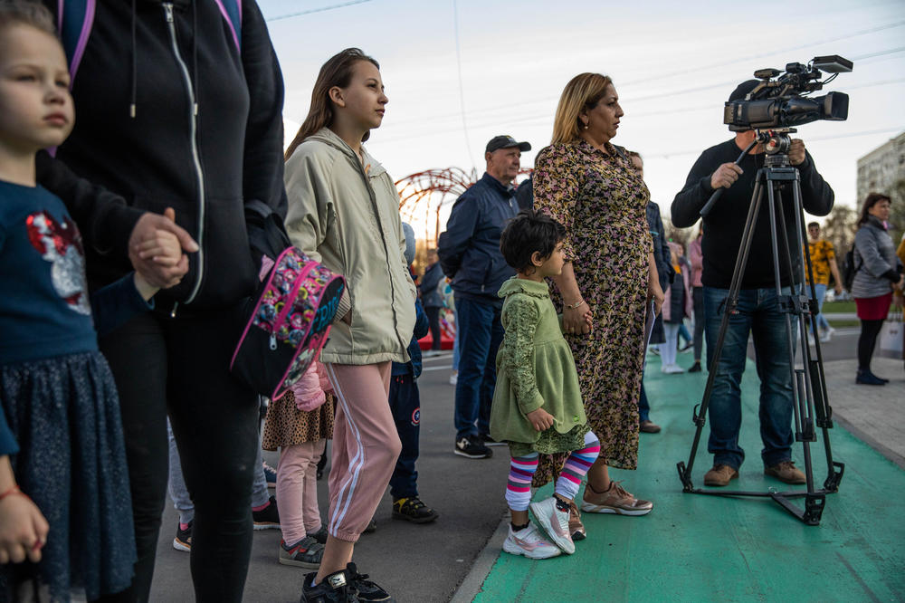 Elena Sirbu, a TV presenter and Roma community mediator, stands with her daughter at an event for International Romani Day in Chisinau, Moldova, on April 8.