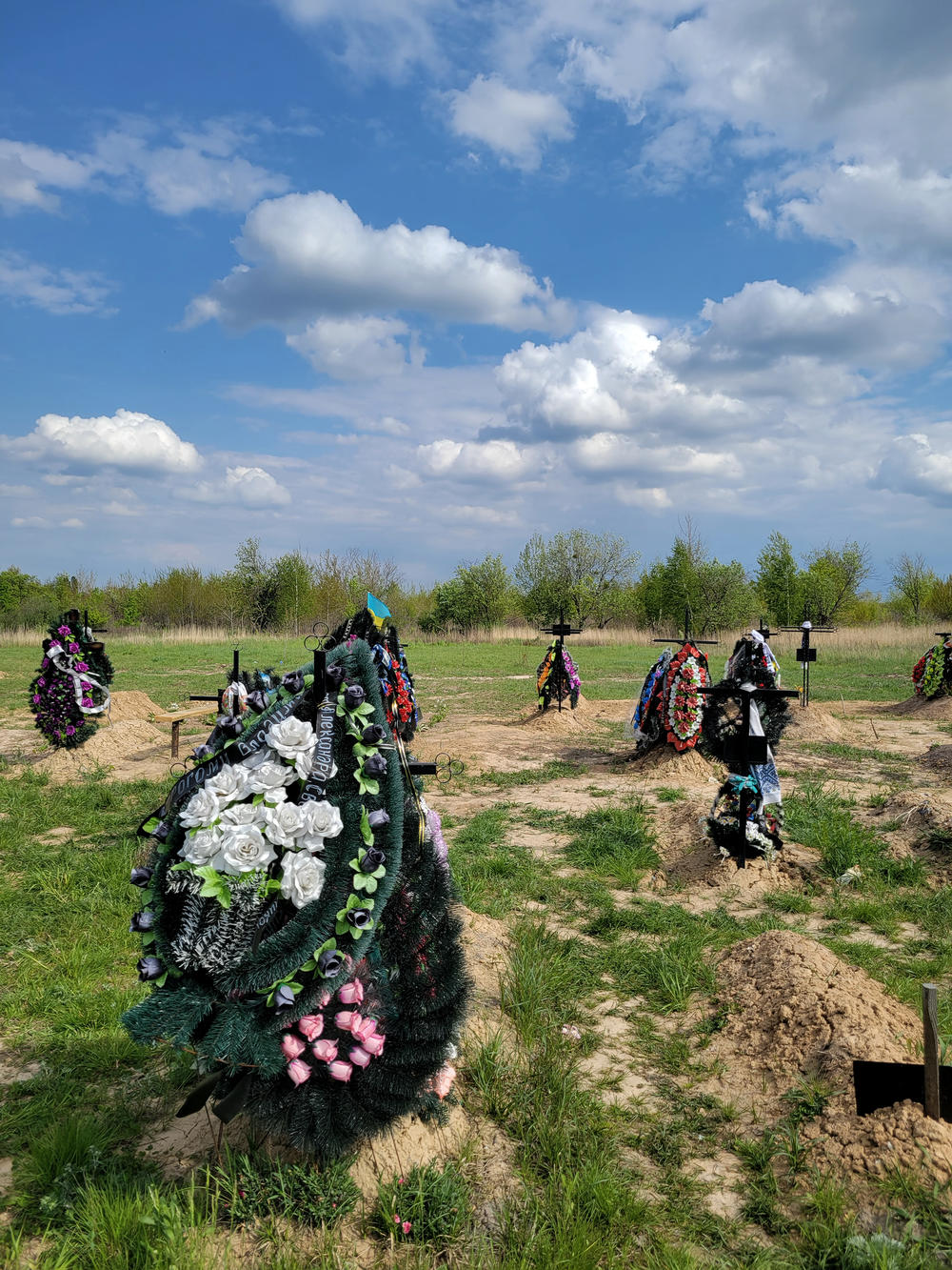 There are many fresh graves in the town's new cemetery.
