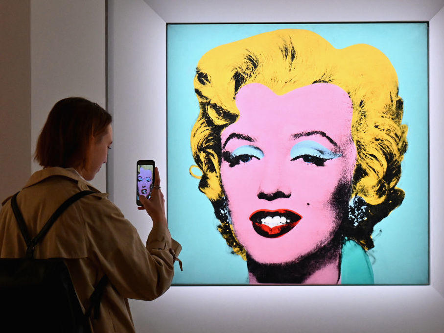 A woman takes a photo of Andy Warhol's 'Shot Sage Blue Marilyn' on April 29 during Christie's 20th and 21st Century Art press preview in New York City.