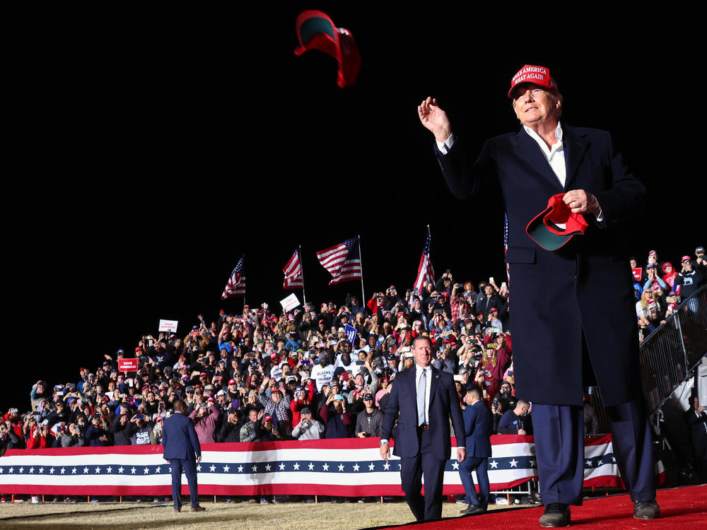 Former President Donald Trump tosses a MAGA hat to the crowd before speaking at a rally in Florence, Ariz., in January.