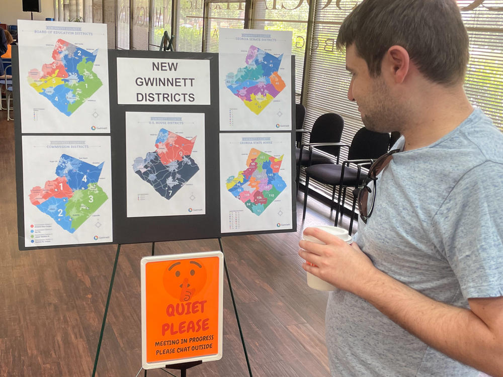 A man looks at newly drawn congressional districts for Gwinnett County, Ga., at a meeting of county Democrats this month.