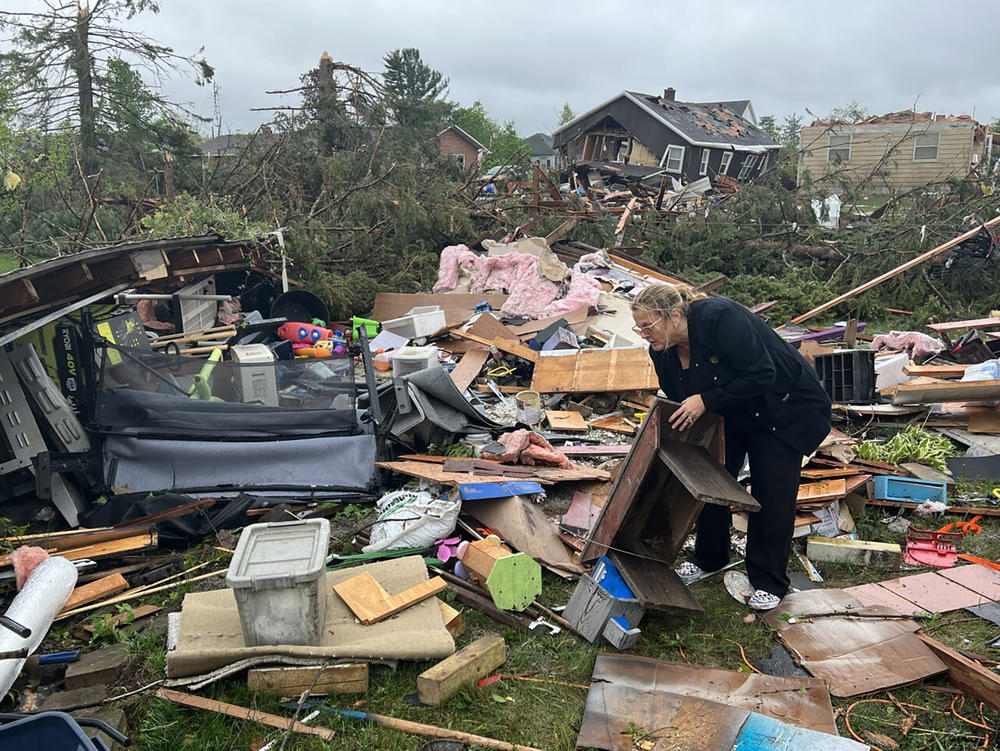 Theresa Haske sorts through debris from what was her garage after a tornado tore through Gaylord, Mich., on Friday. At least two people were killed.
