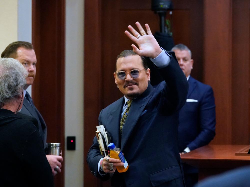 Actor Johnny Depp waves to the gallery as he leaves for a break Monday during his defamation trial in Fairfax, Va. against his ex-wife, Amber Heard.