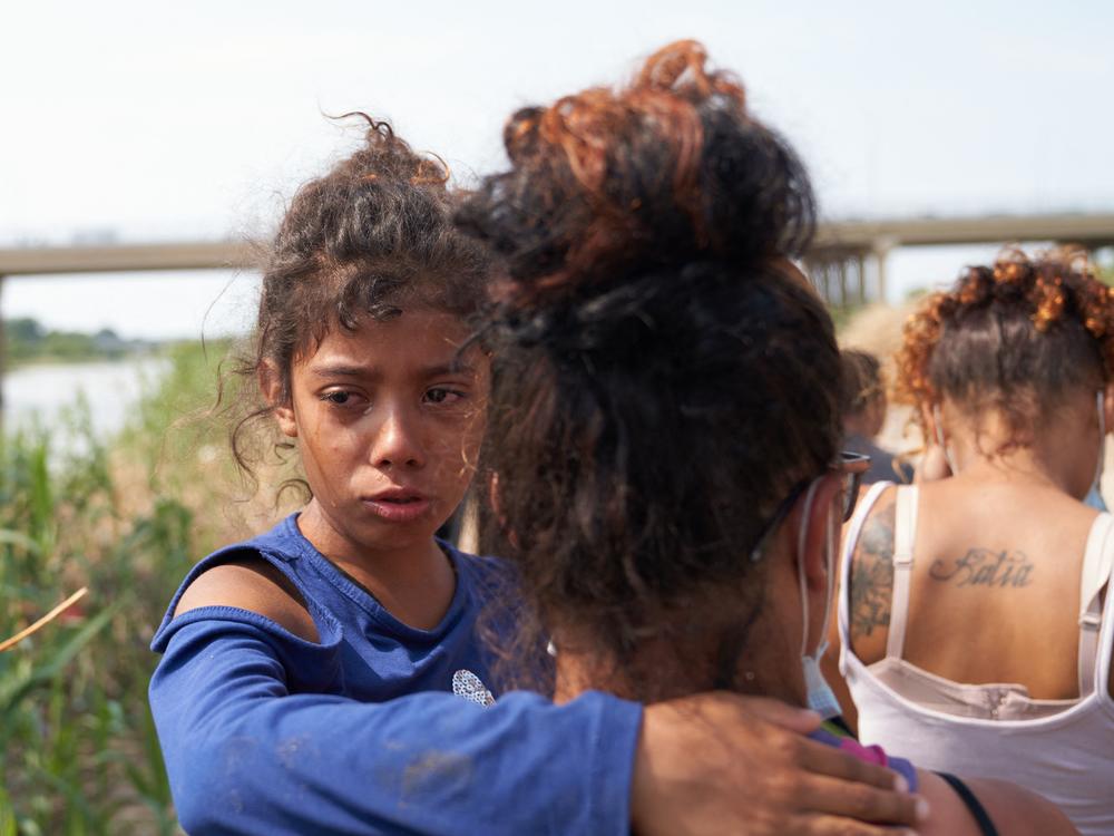 A young migrant cries after illegally crossing the Rio Grande River with her family in Eagle Pass, Texas, on May 22, 2022.