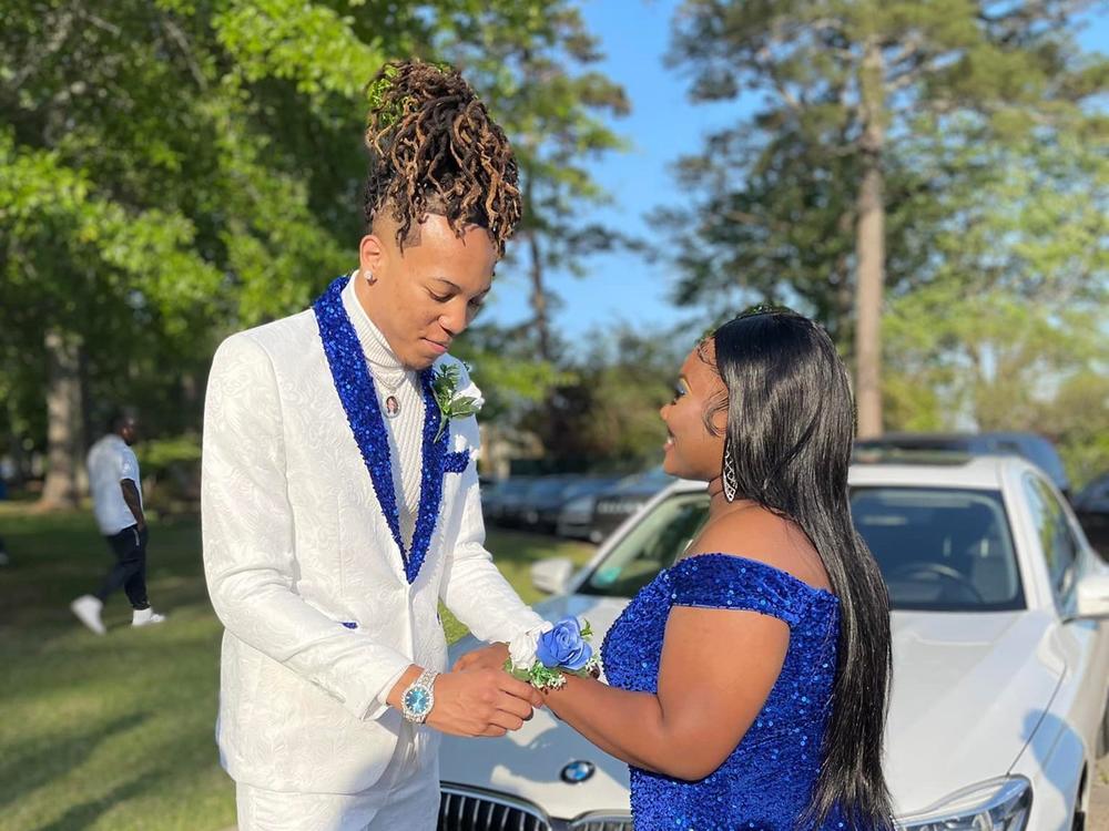 Cameron Frazier and Gabrielle Cistrunk. Cameron wore an embroidered white suit, with blue sequins on the lapel and the bottom of the legs. His shoes featured blue sequin trim.
