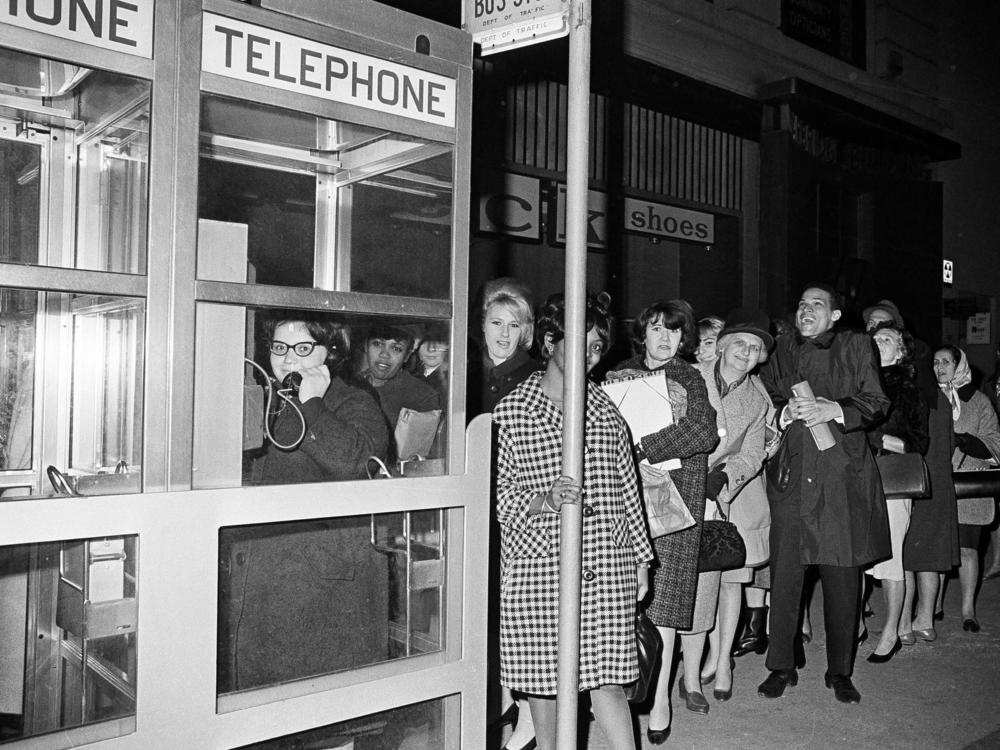Stranded New York workers wait in line at a phone booth to call home during the massive power failure of Nov. 9, 1965. Most of the city's pay phones have been replaced by digital kiosks in recent years.