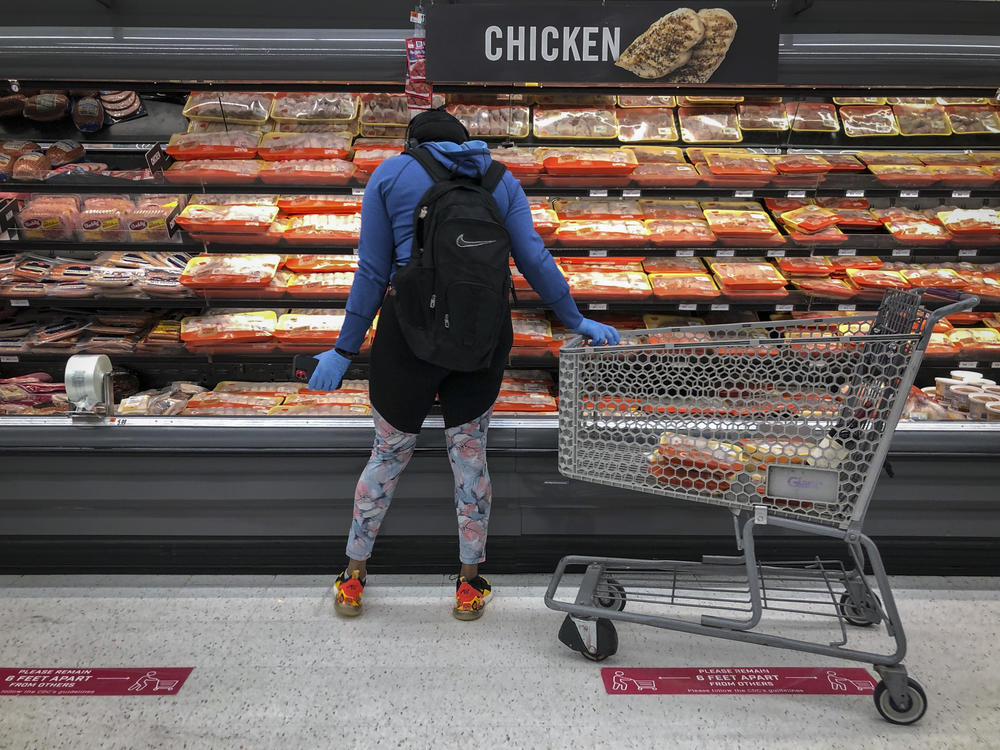 A woman shops for chicken at a grocery store in Washington, D.C., in April 2020.