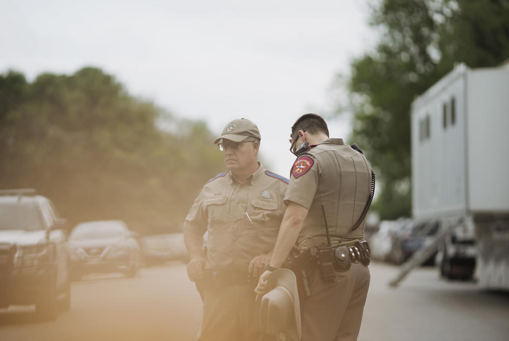 Texas state troopers wait outside Robb Elementary School.