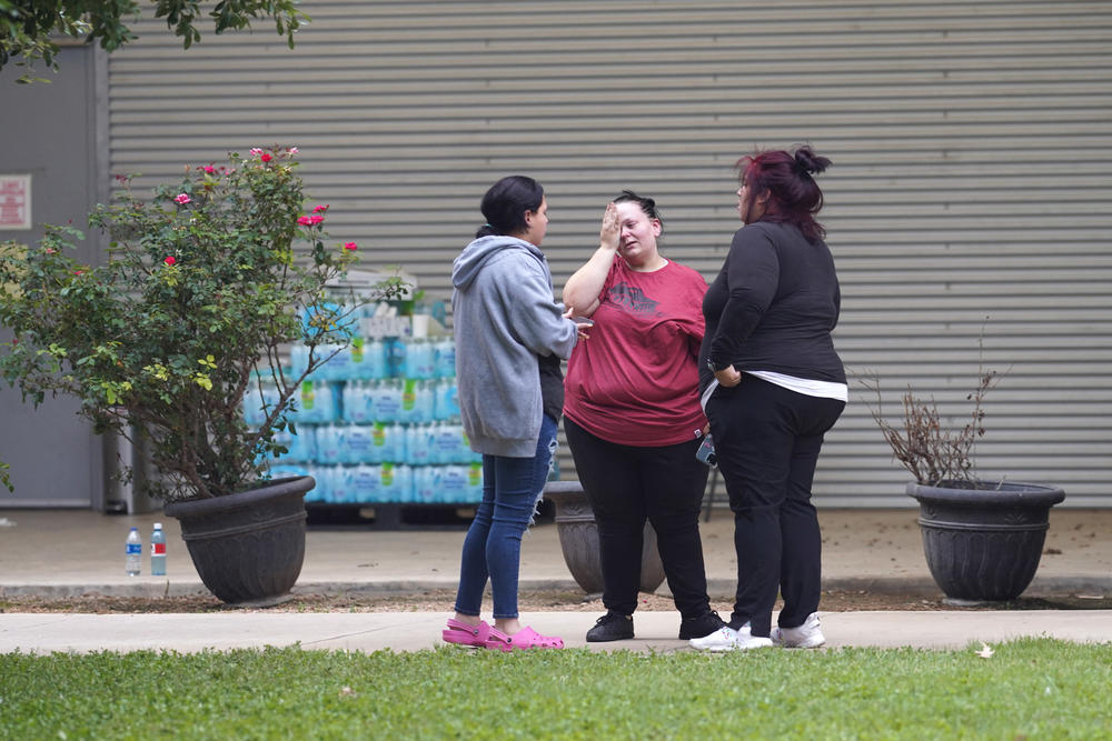 Friends and families gather in mourning outside the Willie de Leon Civic Center where grief counseling will be offered.