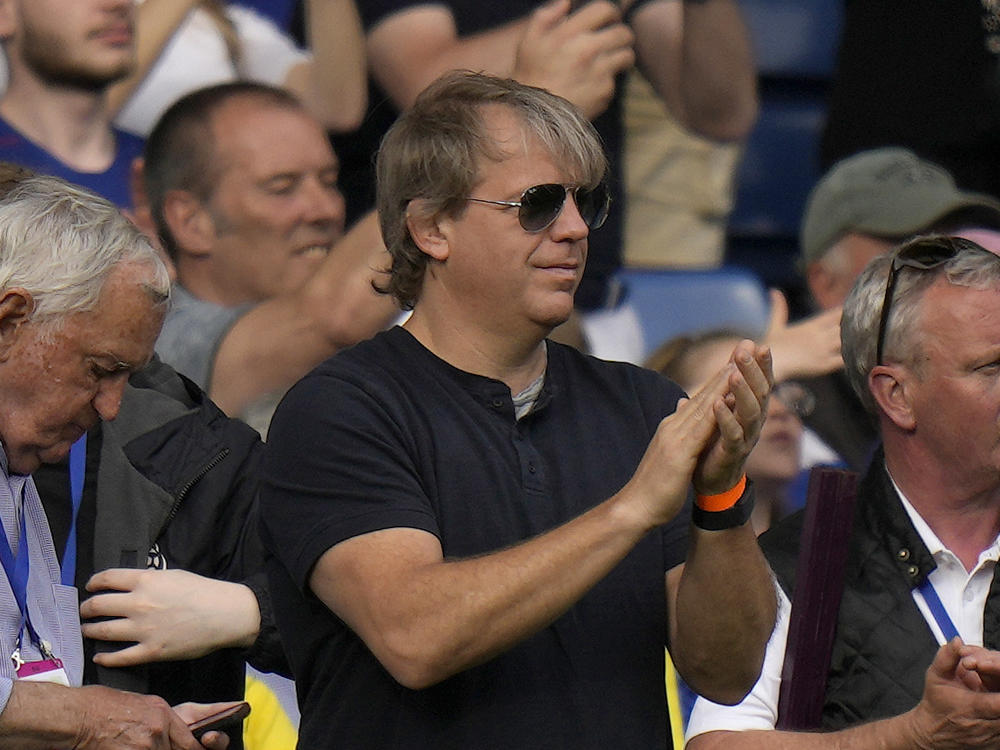 American businessman Todd Boehly, center, applauds as he attends the English Premier League soccer match between Chelsea and Watford at Stamford Bridge stadium in London, Sunday, May 22, 2022.