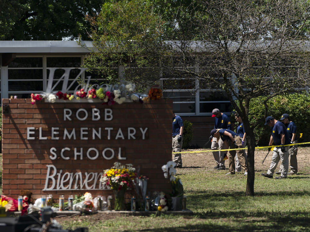Investigators search for evidence outside Robb Elementary School in Uvalde, Texas, on Wednesday, the day after a mass shooting took place there.