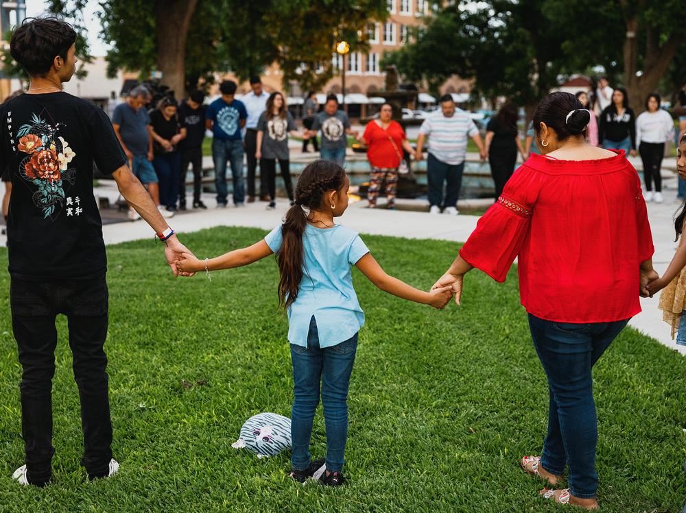 Members of the community gather at the City of Uvalde Town Square for a prayer vigil in the wake of a mass shooting at Robb Elementary School on Tuesday in Uvalde, Texas.
