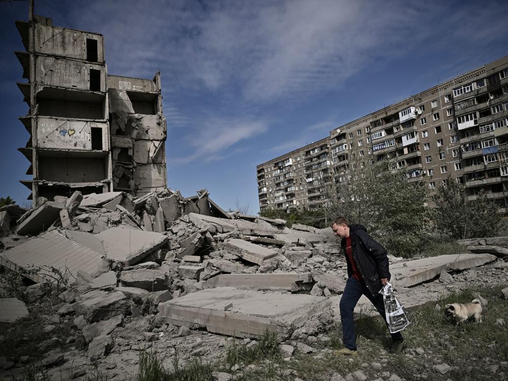 A man walks past a damaged building after a strike in Kramatorsk in the eastern Ukrainian region of Donbas, on Wednesday.