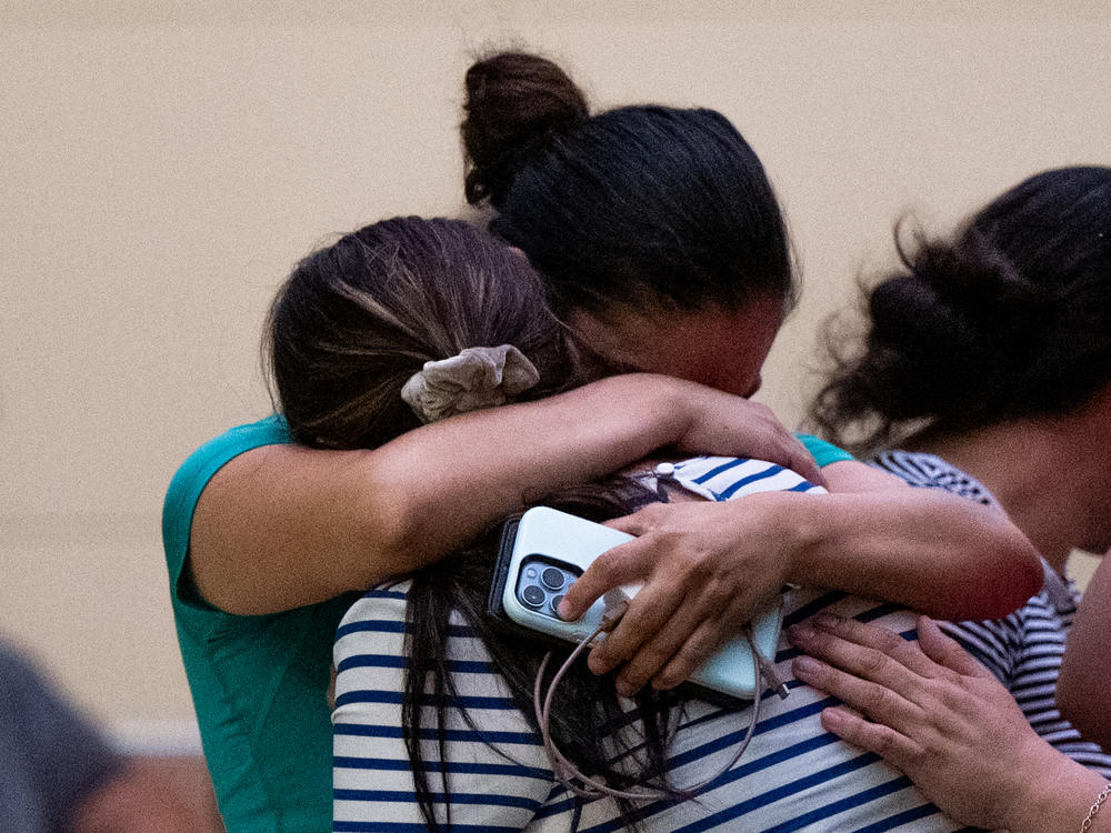 People mourn outside of the SSGT Willie de Leon Civic Center following the mass shooting at Robb Elementary School on Tuesday in Uvalde, Texas.