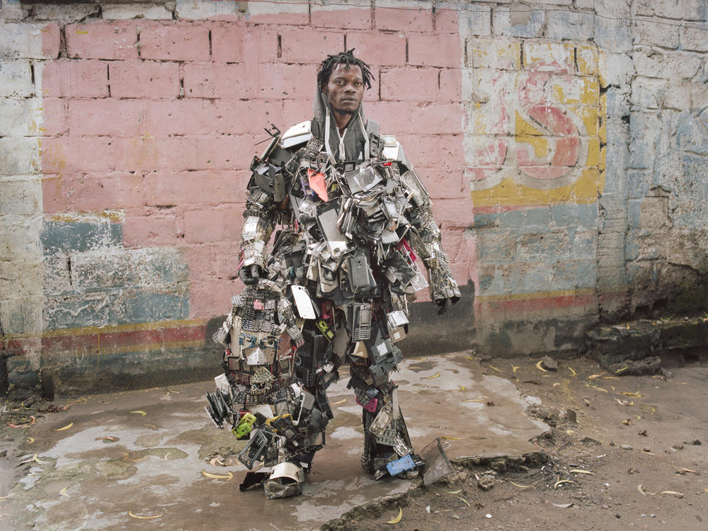 Nada Thsibwabwa poses in a robot-like costume that he created using old mobile phones, in Matonge district, Kinshasa. The country is a major producer of coltan, an ore used in cellphones and other electronics.