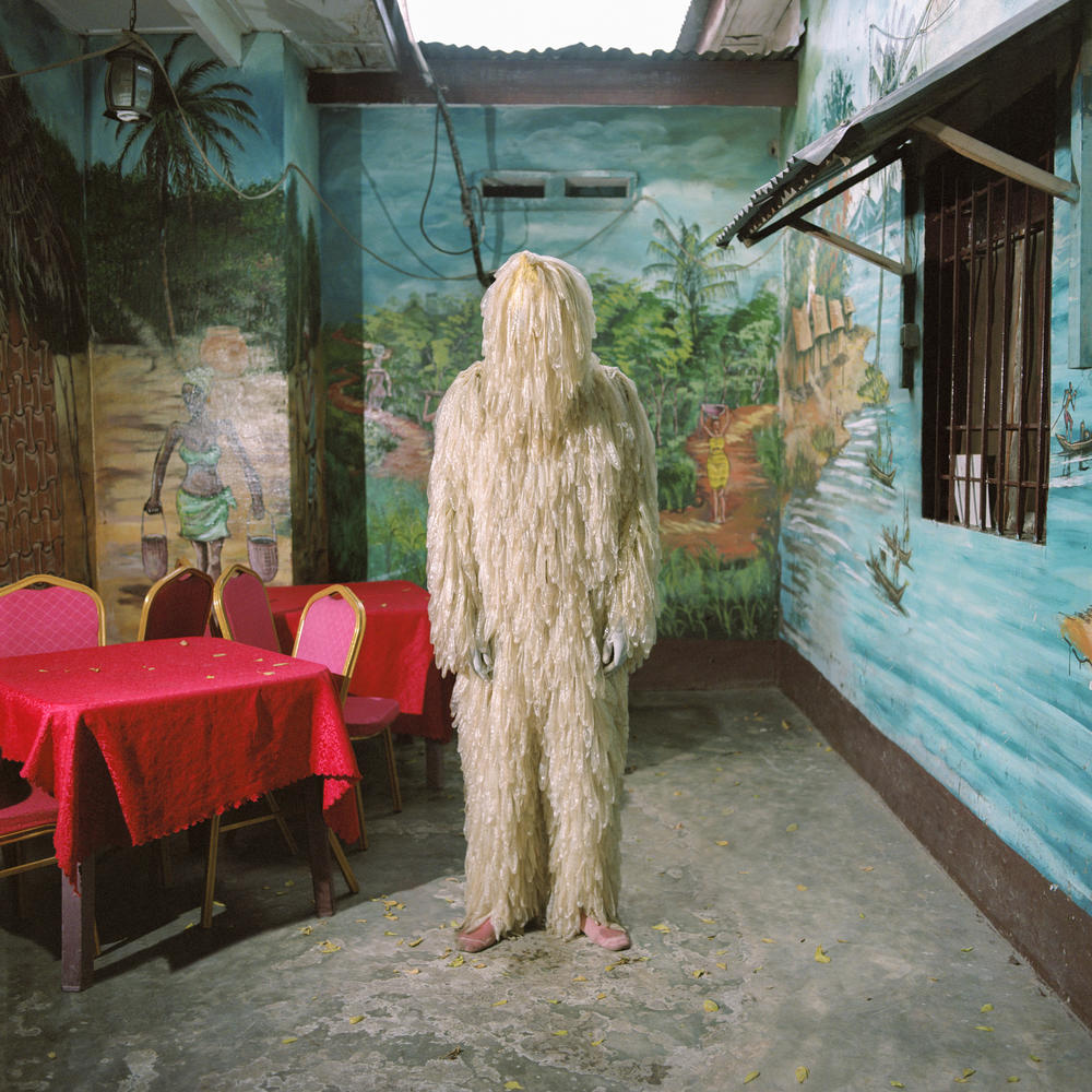 Look closer and you'll see that Tickson Mbuyi's Chewbacca-looking costume is actually made of unrolled condoms. He wears it at the Bon Marché district of Kinshasa, a popular nightlife neighborhood — and hopes that it draws attention to 