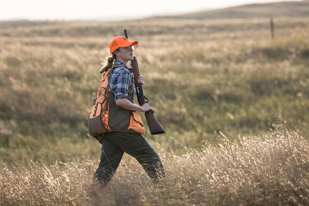 Marissa Jensen, an education and outreach program manager at Pheasants Forever, hunts sharp-tailed grouse in the Nebraska Sandhills. More than 65% of the organization's funds are spent on habitat restoration, which includes restoring fire to the landscape through prescribed burns. According to the NRCS, even three trees per acre can displace grassland birds from the native prairie.