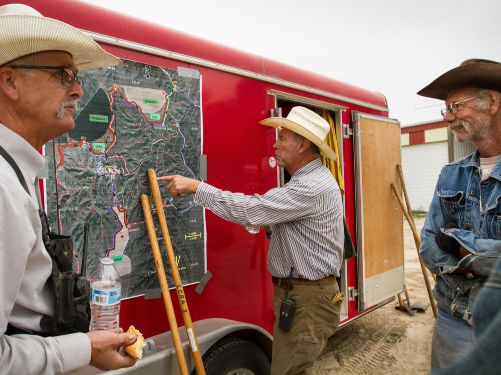 A detailed satellite map delineates the burn perimeter and provides vital pre-burn planning and safety information. The trailer is filled with supplies ranging from rakes and shovels to flame-retardant clothing.