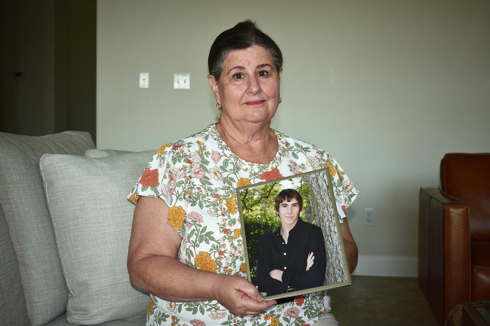 Sue Phillips holds a photograph of her son, Matthew. He died after two members of a white supremacist gang beat him until he was unconscious in a recreation cage at Thomson.