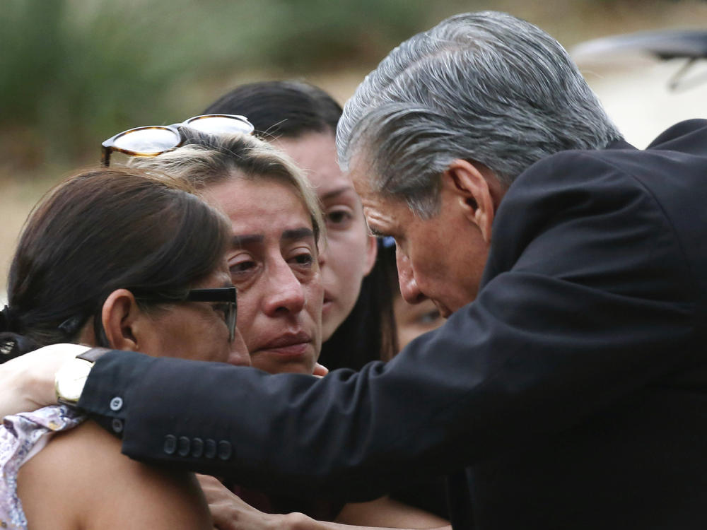 The archbishop of San Antonio, Gustavo Garcia-Siller, comforts families outside the Civic Center following a deadly school shooting at Robb Elementary School in Uvalde, Texas, Tuesday, May 24, 2022.