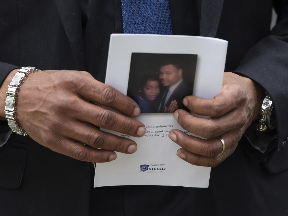 A person holds a program for the funeral service for Aaron Salter Jr. at The Chapel on Crosspoint on Wednesday, May 25, in Getzville, N.Y.