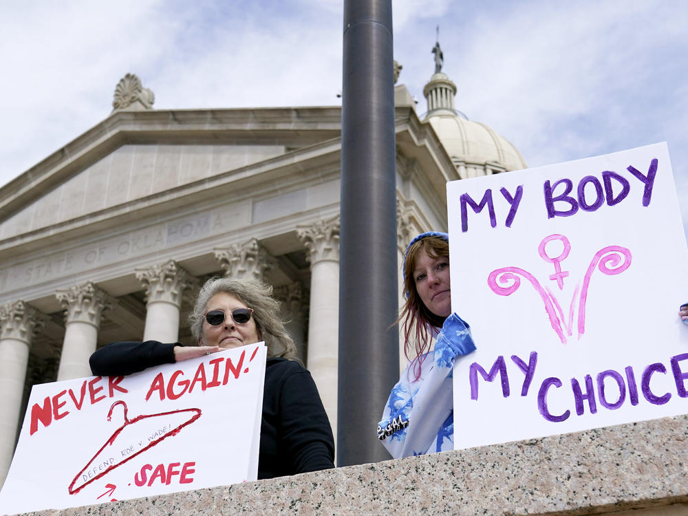 Dani Thayer, left, and Marina Lanae, right, both of Tulsa, Okla., hold pro-choice signs at the state Capitol, Wednesday, April 13, 2022, in Oklahoma City.