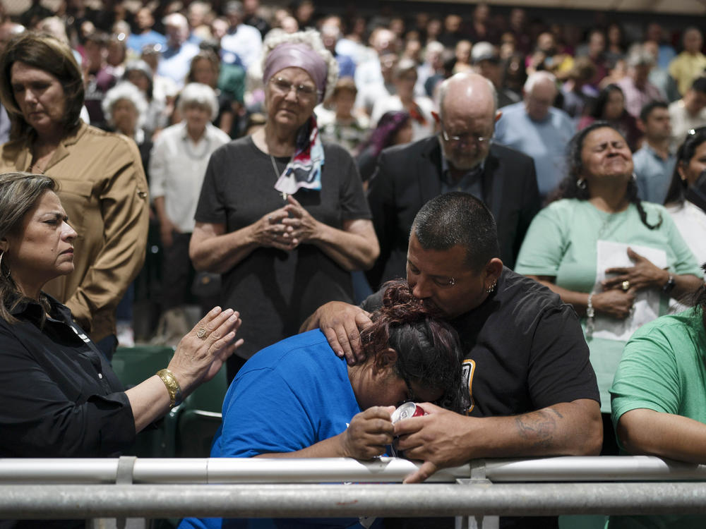 Two family members of one of the victims killed in Tuesday's shooting at Robb Elementary School comfort each other during a prayer vigil in Uvalde, Texas, Wednesday, May 25, 2022.