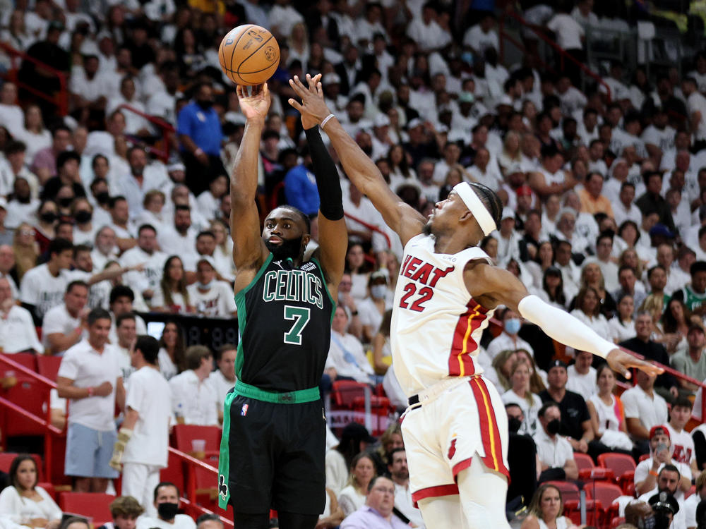 Jaylen Brown of the Boston Celtics shoots the ball against Jimmy Butler of the Miami Heat during the fourth quarter in Game Five of the 2022 NBA Playoffs Eastern Conference Finals at FTX Arena on May 25, 2022 in Miami.