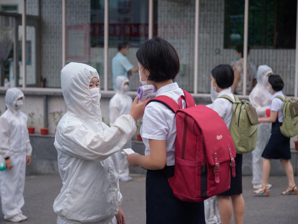 Students of the Pyongyang Jang Chol Gu University of Commerce in North Korea undergo temperature checks before entering the campus. The country said there were no cases — until May 12.