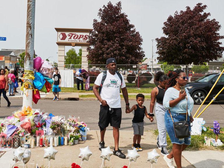 Community members gather May 21 to support each other near the Tops market that was targeted in a racist mass shooting in Buffalo, N.Y.