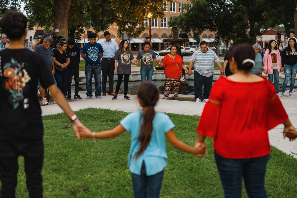 Members of the community gather at the City of Uvalde Town Square for a prayer vigil in the wake of a mass shooting at Robb Elementary School.