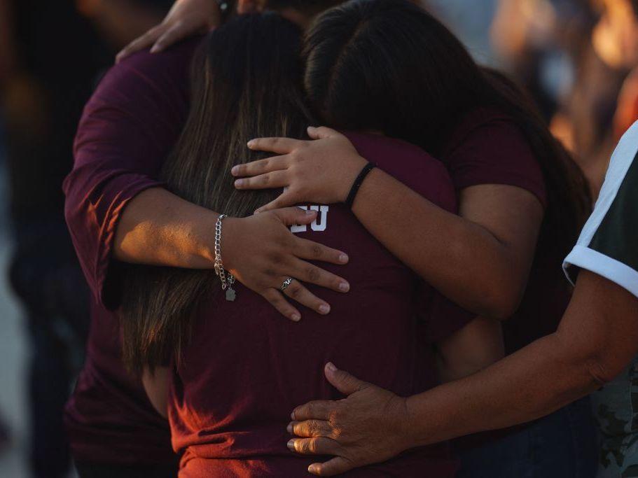 People mourn Wednesday as they attend a vigil for the victims of the mass shooting at Robb Elementary School in Uvalde, Texas.