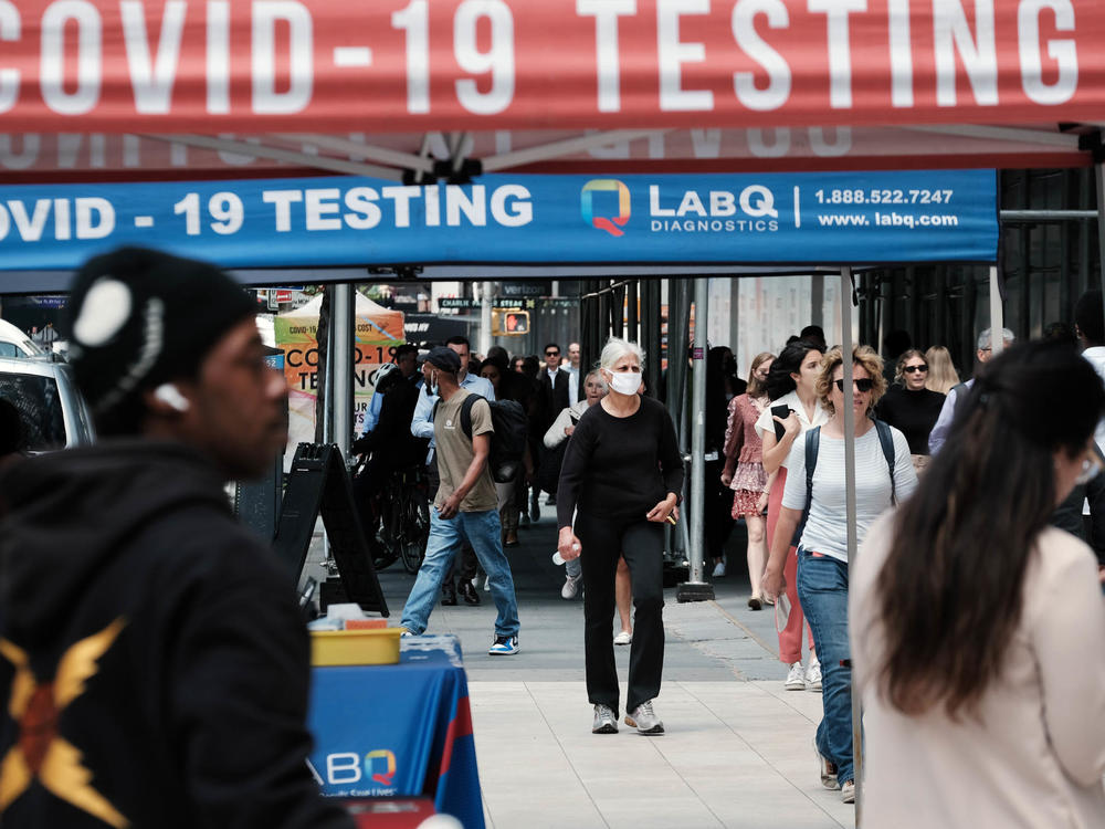 People walk past a COVID testing site on May 17 in New York City. New York's health commissioner, Dr. Ashwin Vasan, has moved from a 