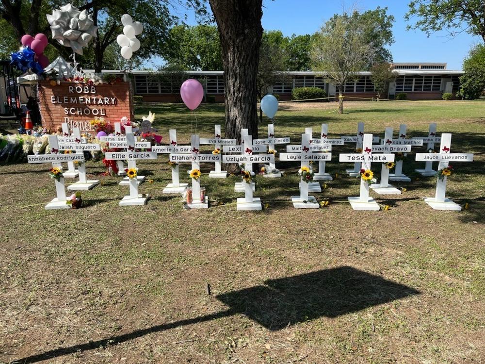 A memorial to the students and faculty who died stands in front of Robb Elementary School in Uvalde, Texas. It's not clear who put the memorial up and authorities have not released the names of the deceased.
