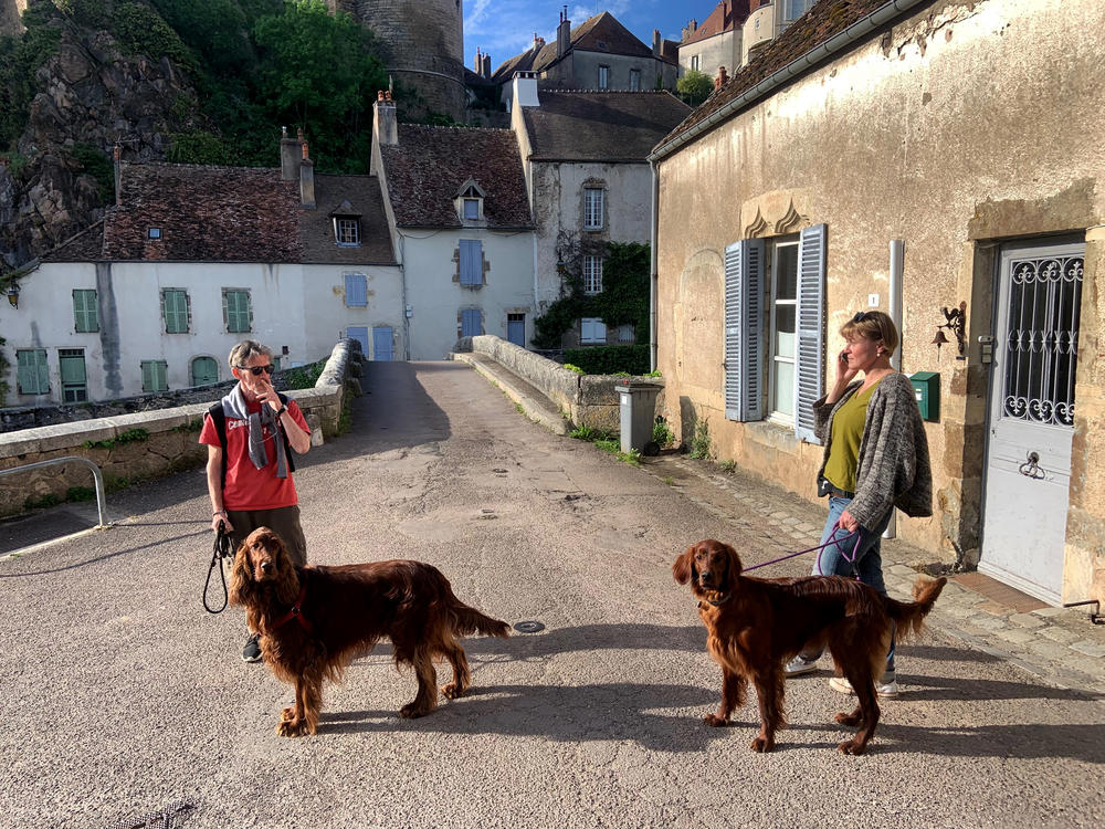 Yuri Mazurenko and Macha Levitin get ready to go on a walk with their dogs Rolly and Safra in a village in Burgundy, France.