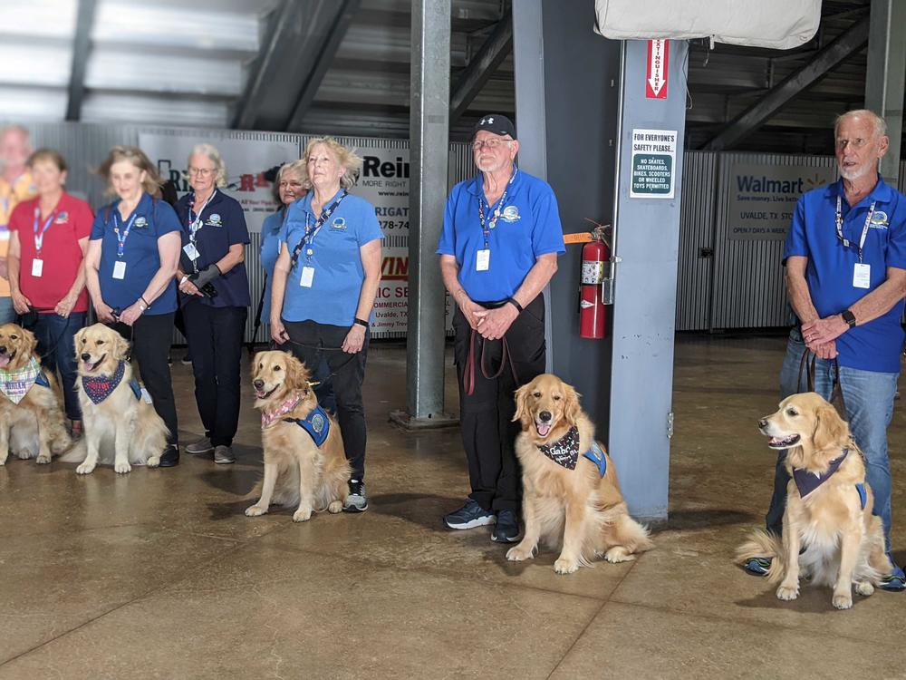 Volunteers and comfort dogs attend a vigil in Uvalde, Texas, on Wednesday.