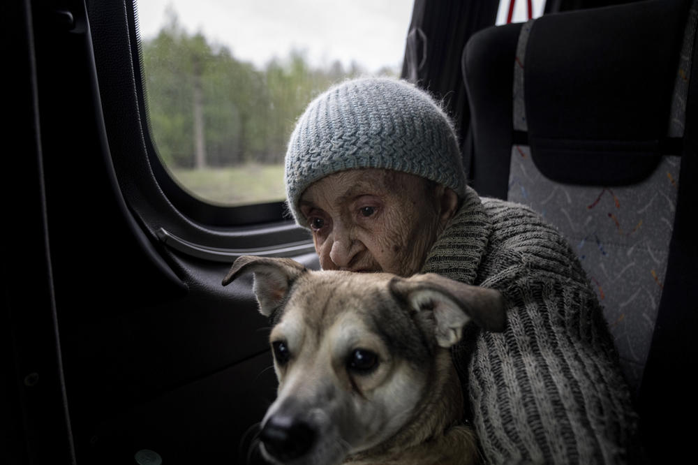 A woman sits on a bus with her dog during evacuation from Lyman, Donetsk region, eastern Ukraine, April 30.