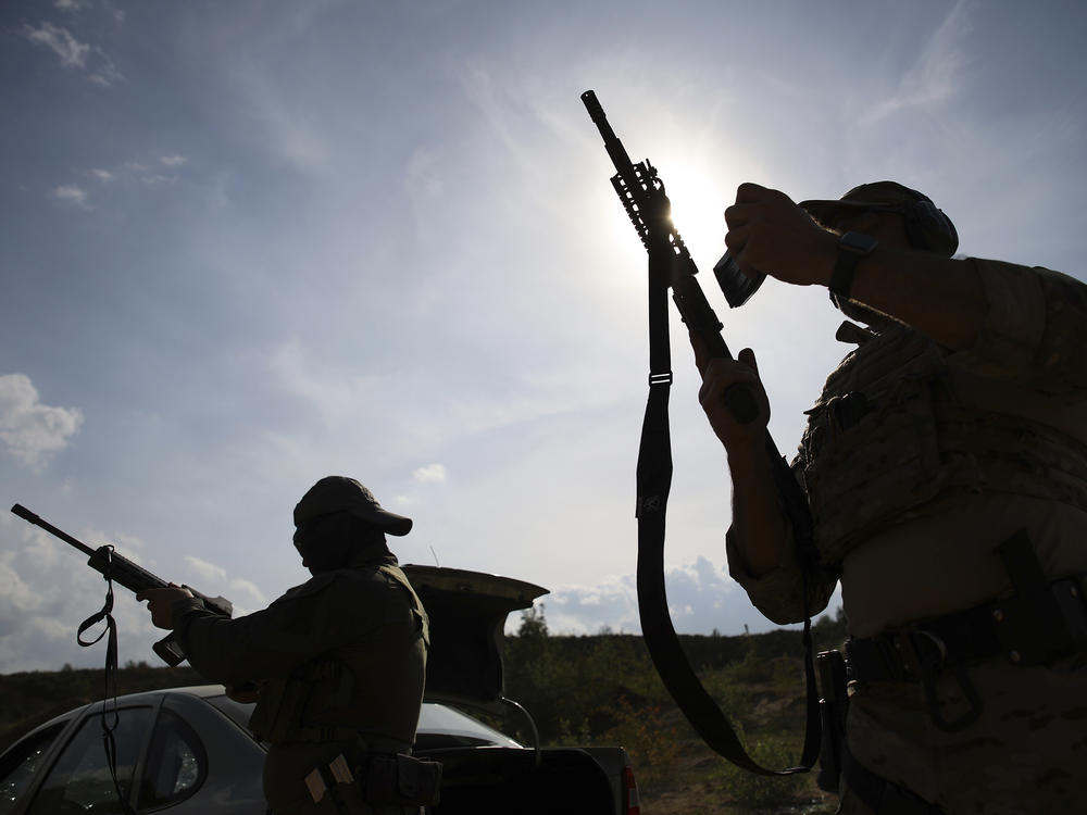 Volunteers from Belarus practice at a shooting range near Warsaw, Poland, on May 20. Belarusians are among those who have answered a call by Ukrainian President Volodymyr Zelenskyy for foreign fighters to go to Ukraine and join the International Legion for the Territorial Defense of Ukraine.