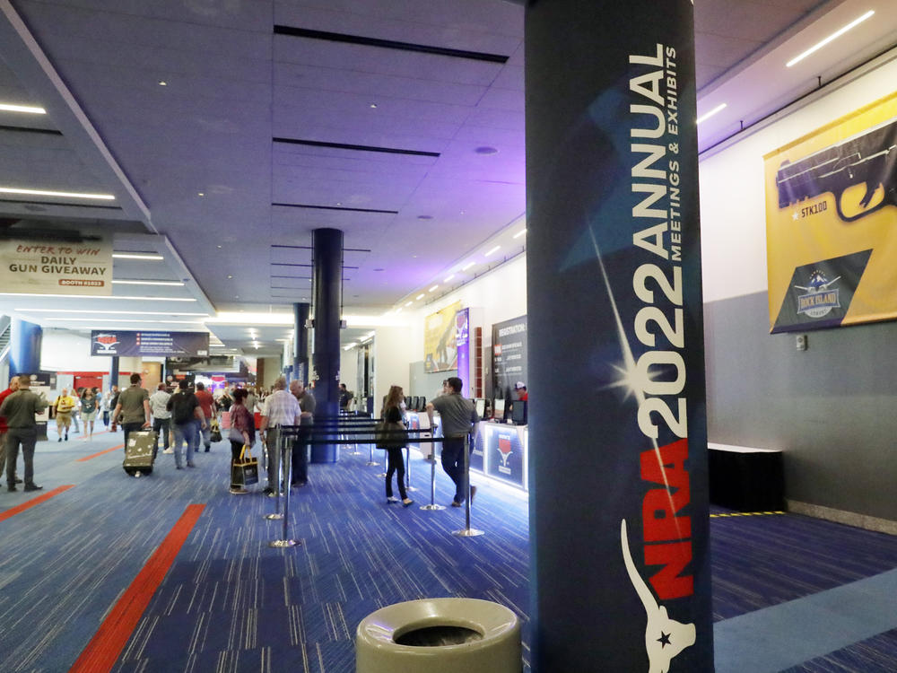 Attendees of the NRA's annual convention gather by booths in the exhibit halls of the George R. Brown Convention Center in Houston on Thursday.