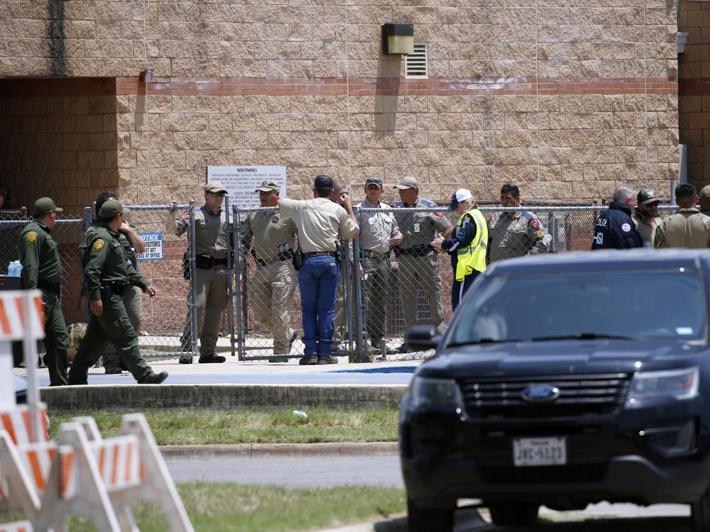 Law enforcement and first responders gather outside Robb Elementary School following Tuesday's shooting in Uvalde, Texas. Their response has since come under wide scrutiny.