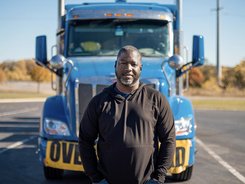 Heavy haul trucker Eric Jammer stands in front of his truck.