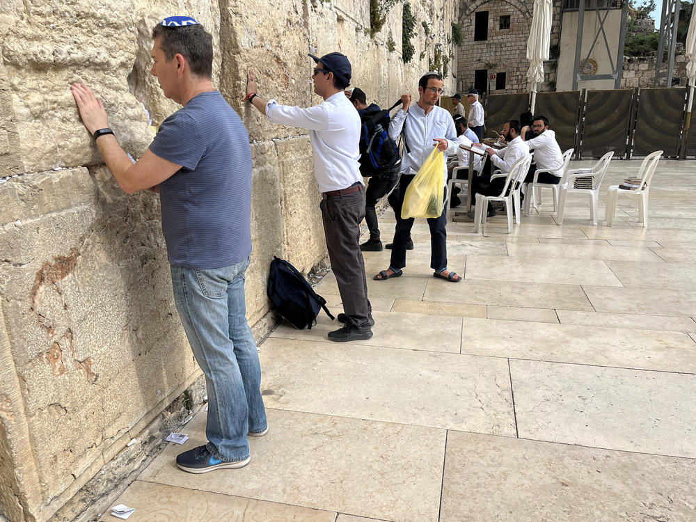 Ahmed Quraishi (second from left), a Pakistani TV news anchor, stands at the Western Wall prayer site in Jerusalem in May. His participation in the rare Pakistani visit sparked a backlash back home, prompting Pakistani state-run TV to fire him.