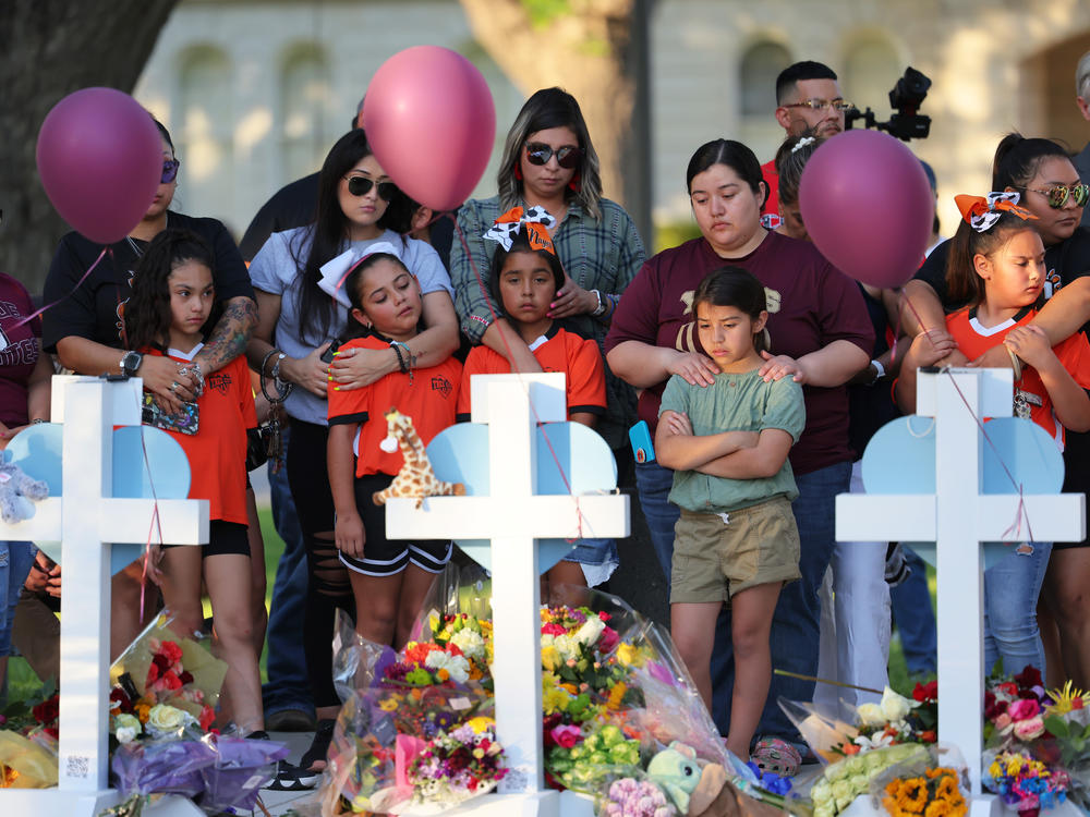 People visit memorials Thursday for victims of the mass shooting at Robb Elementary School in Uvalde, Texas.