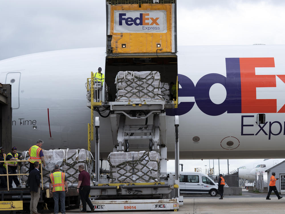 Workers unload a FedEx cargo plane carrying 100,000 pounds of baby formula at Washington Dulles International Airport, in Chantilly, Va., on Wednesday.