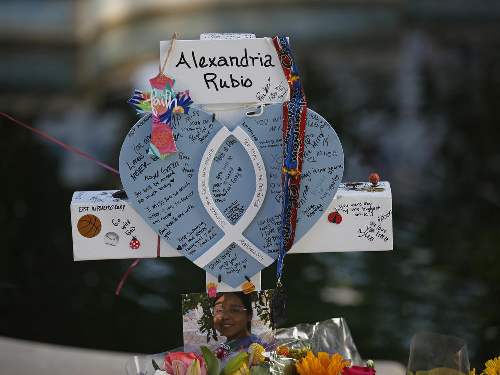 Alexandria Rubio's cross stands Friday at a memorial site for the victims killed in this week's shooting at Robb Elementary School in Uvalde, Texas.