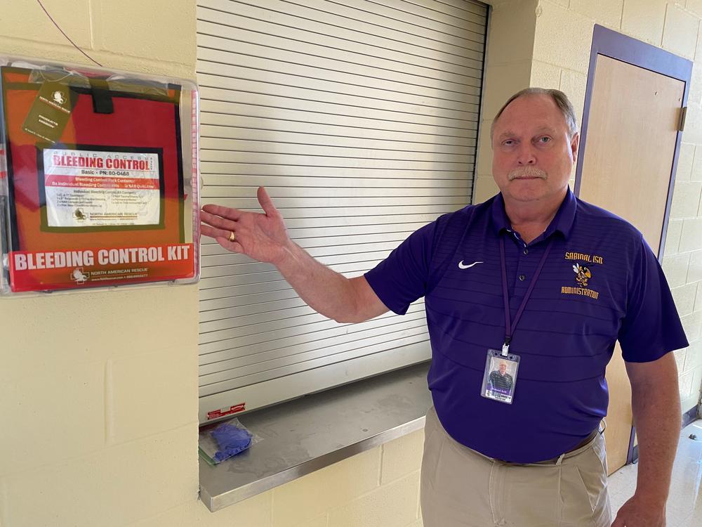 Sabinal School Superintendent Richard Grill points out a bleeding control kit at Sabinal High School. Visitors to Sabinal schools have to ring a bell and show identification via a camera before they are allowed inside.