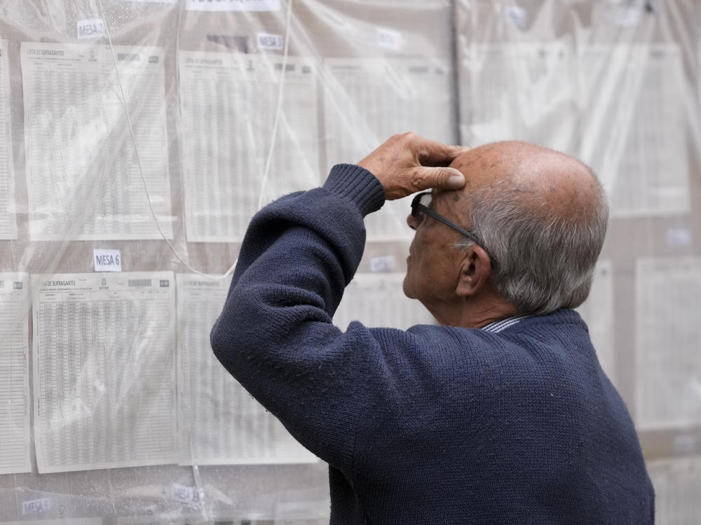 A man looks for his polling post during presidential elections in Bogota, Colombia, Sunday, May 29, 2022.